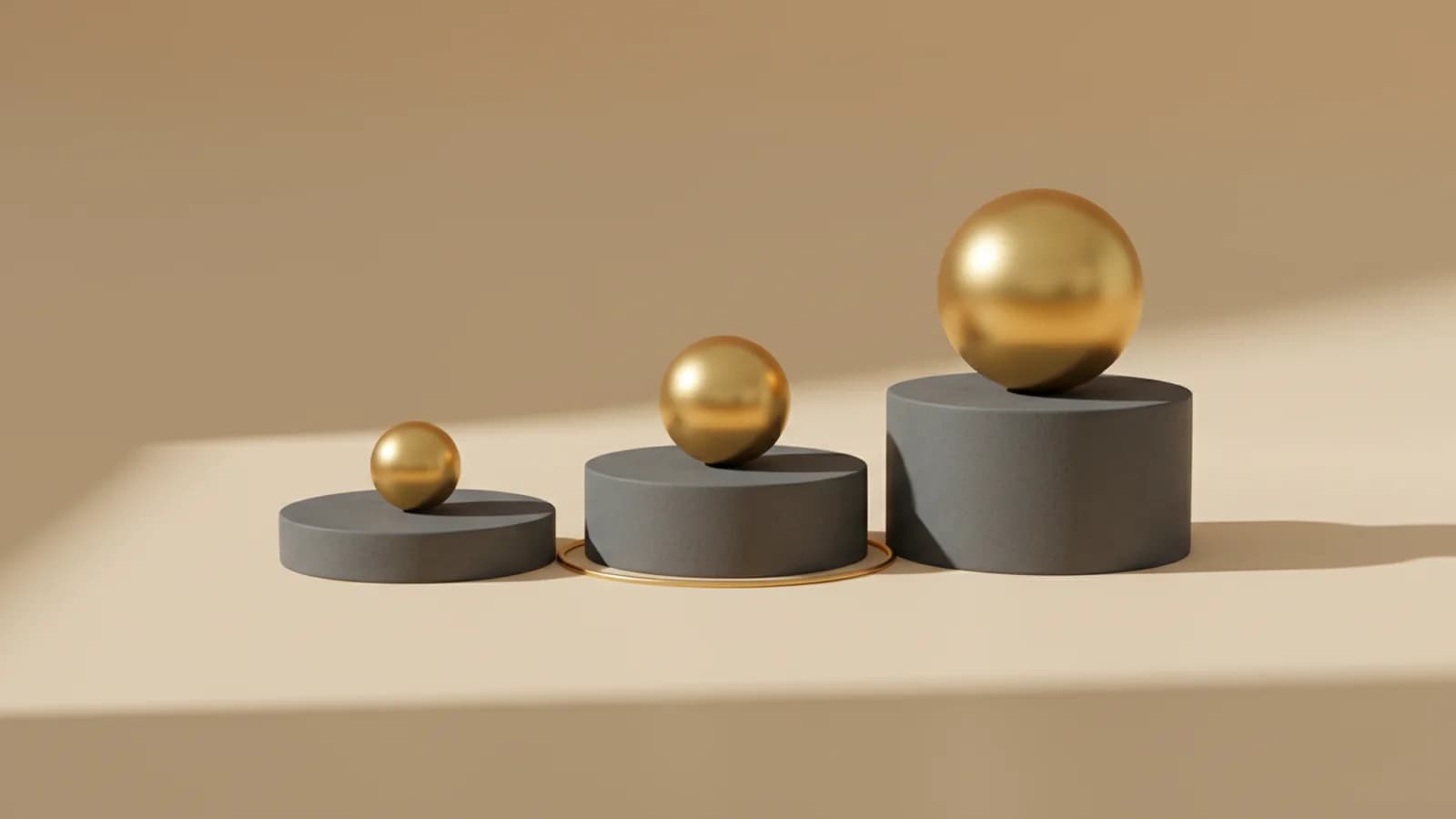 Three graphite podiums of rising height, each carrying a polished gold sphere